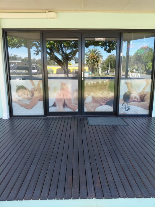 Owner Amy smiling in front of Total Massage House